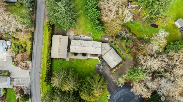 Set on 1.13 acres, a serene, park-like setting with mature trees, natural landscaping, and open level spaces.