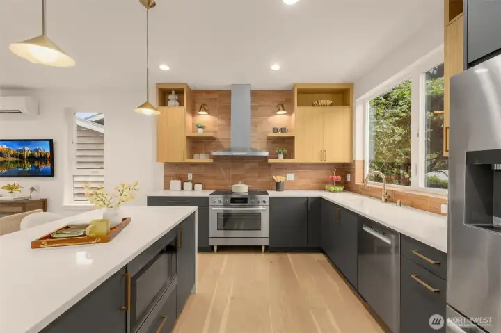 Photos of similar home, with quartz counters, full height tile, and a stainless appliance suite. Thoughtful storage keeps the look clean and functional.