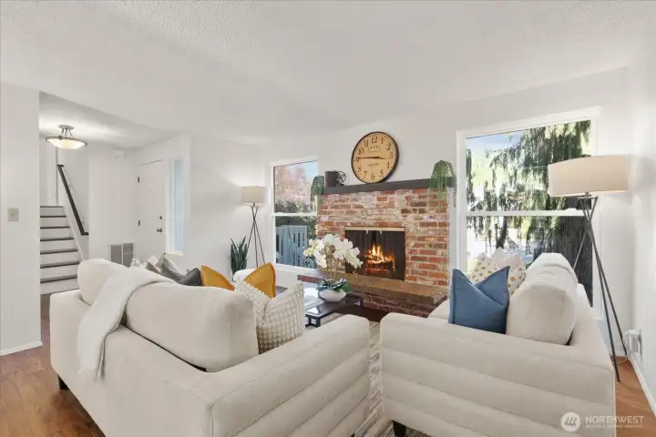 Large windows frame views of the beautifully maintained front lawn.