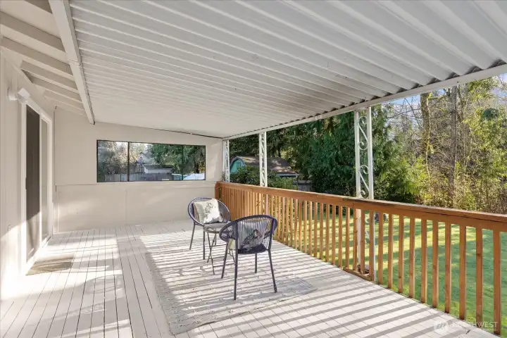 The covered back deck is truly built for entertaining and year-round enjoyment. It offers a seamless extension of indoor living space. Whether hosting friends or enjoying quiet mornings, it delivers comfort in every season.