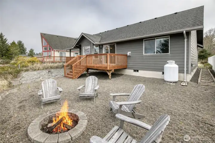 Backyard is ready for entertaining with the built in firepit