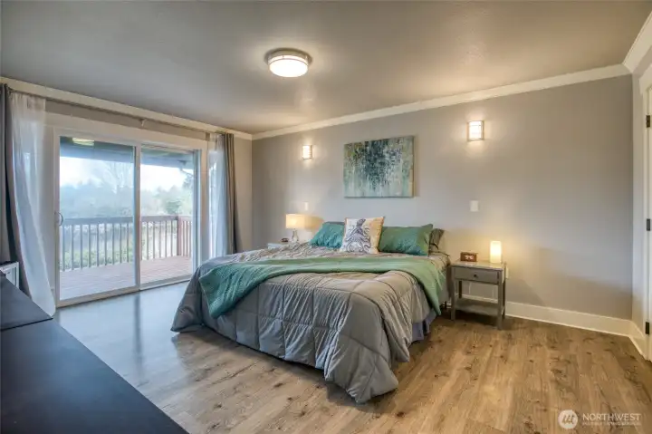Primary ensuite is located on opposite end of house for privacy. Sliding door to cozy back deck great for sunsets or morning canal watching.