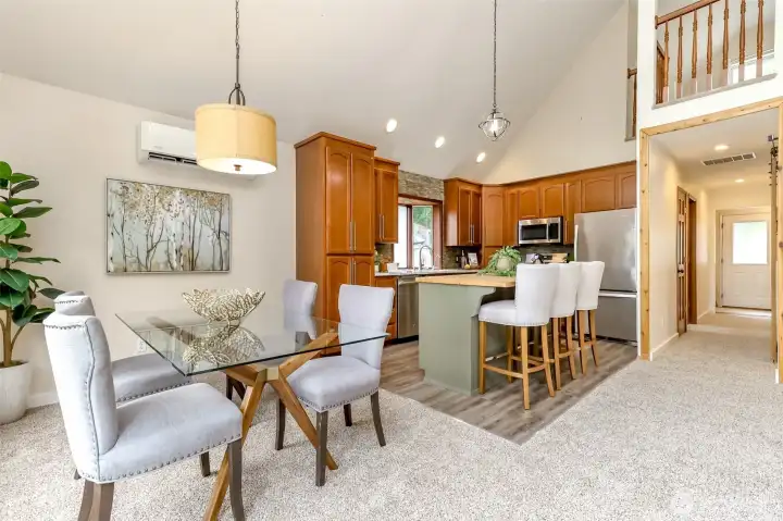 Dining room with view to entry hall, primary bedroom and full bath.