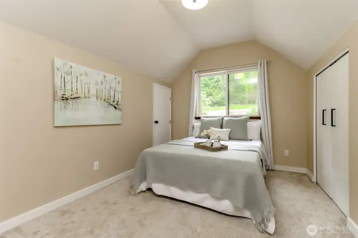 Loft bedroom with closets on either side of the bedroom.