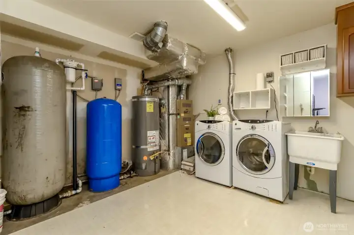 Large utility room / mechanical room for water treatment , furnace and hot water tank.