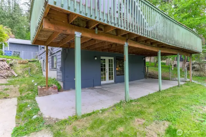 Downstairs French doors lead to full length patio. Septic tanks to the left of the house.