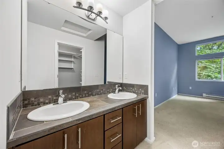 Full primary bathroom featuring dual sinks and plenty of counter space for added comfort and convenience.