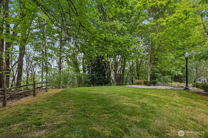 Serene greenbelt setting offers added privacy and a tranquil natural backdrop.