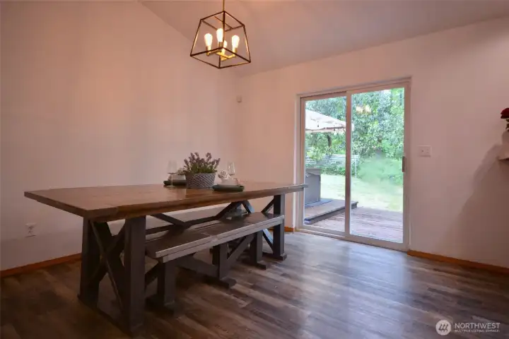 The dining room offers an abundance of space for gatherings and entertaining, with an easy flow into both the living room and kitchen. A sliding glass door leads directly to the expansive back deck, making indoor and outdoor entertaining effortless. The dining room offers an abundance of space for gatherings and entertaining, with an easy flow into both the living room and kitchen. A sliding glass door leads directly to the expansive back deck, making indoor and outdoor entertaining effortless.