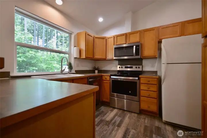 The kitchen is designed with functionality in mind, featuring ample cabinet storage, generous counter space, and a built-in desk area perfect for a coffee bar, workspace, or additional prep area. The kitchen is designed with functionality in mind, featuring ample cabinet storage, generous counter space, and a built-in desk area perfect for a coffee bar, workspace, or additional prep area.