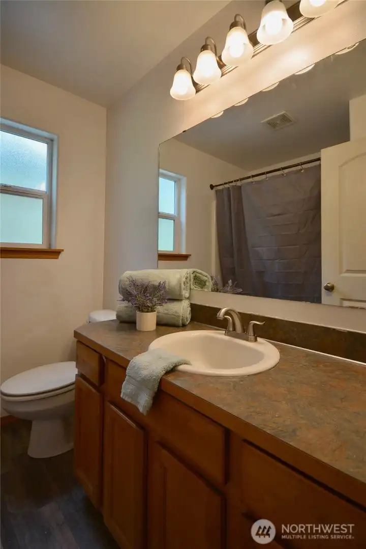 Guest bathroom features full bath and a vanity that offers lots of counter space. Guest bathroom features full bath and a vanity that offers lots of counter space.
