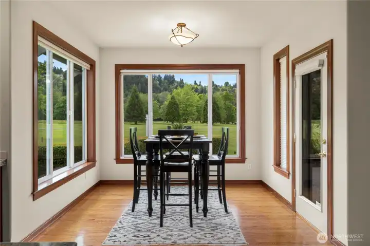 A cozy eating nook offers beautiful golf course views and easy access to the patio.