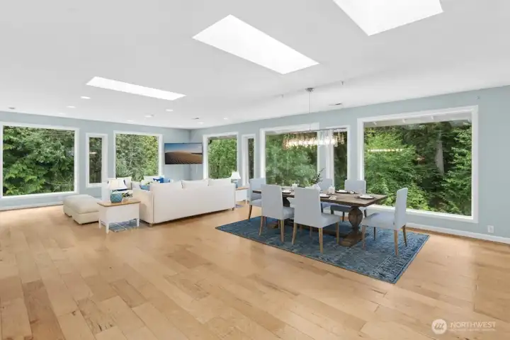 Inside, wall of windows frames peaceful views of the surrounding greenery, creating a seamless connection to the outdoors. The light-filled main level features beautiful wood floors, an updated kitchen, skylights, and an open-concept design perfect for everyday entertaining Inside, wall of windows frames peaceful views of the surrounding greenery, creating a seamless connection to the outdoors. The light-filled main level features beautiful wood floors, an updated kitchen, skylights, and an open-concept design perfect for everyday entertaining
