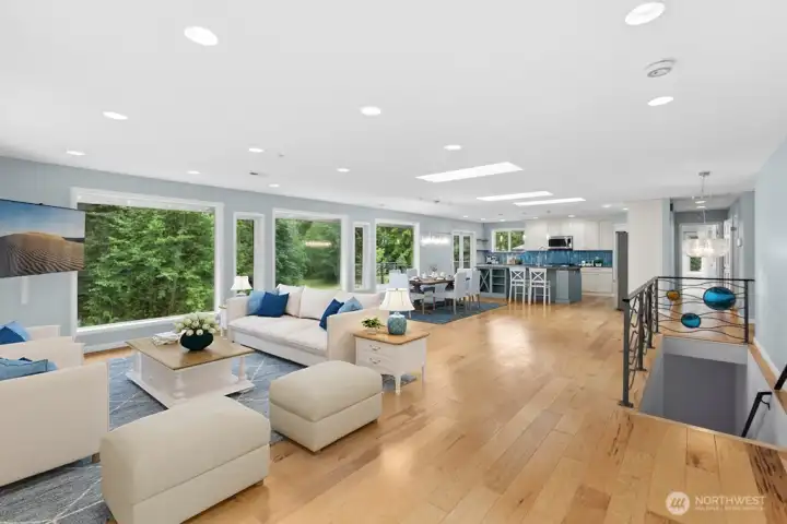 Inside, wall of windows frames peaceful views of the surrounding greenery, creating a seamless connection to the outdoors. The light-filled main level features beautiful wood floors, an updated kitchen, skylights, and an open-concept design perfect for everyday entertaining Inside, wall of windows frames peaceful views of the surrounding greenery, creating a seamless connection to the outdoors. The light-filled main level features beautiful wood floors, an updated kitchen, skylights, and an open-concept design perfect for everyday entertaining