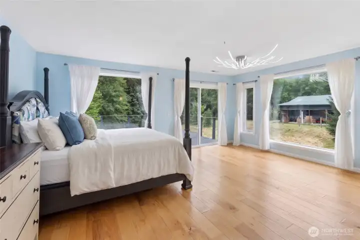 The primary suite features deck access and an updated en-suite bath with tile flooring, a tiled walk-in shower, and a separate soaking tub. The primary suite features deck access and an updated en-suite bath with tile flooring, a tiled walk-in shower, and a separate soaking tub.