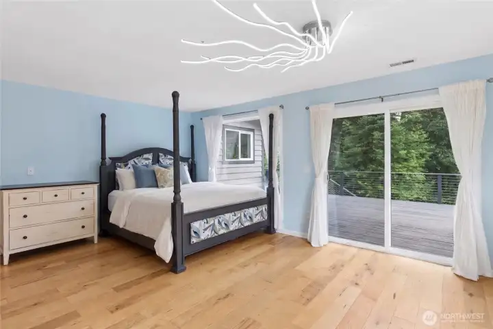 The primary suite features deck access and an updated en-suite bath with tile flooring, a tiled walk-in shower, and a separate soaking tub. The primary suite features deck access and an updated en-suite bath with tile flooring, a tiled walk-in shower, and a separate soaking tub.