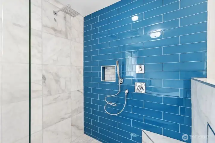 The primary suite features deck access and an updated en-suite bath with tile flooring, a tiled walk-in shower, and a separate soaking tub. The primary suite features deck access and an updated en-suite bath with tile flooring, a tiled walk-in shower, and a separate soaking tub.