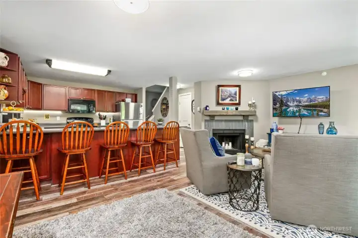 Open floor plan with tile surround fireplace and custom wood hearth Open floor plan with tile surround fireplace and custom wood hearth
