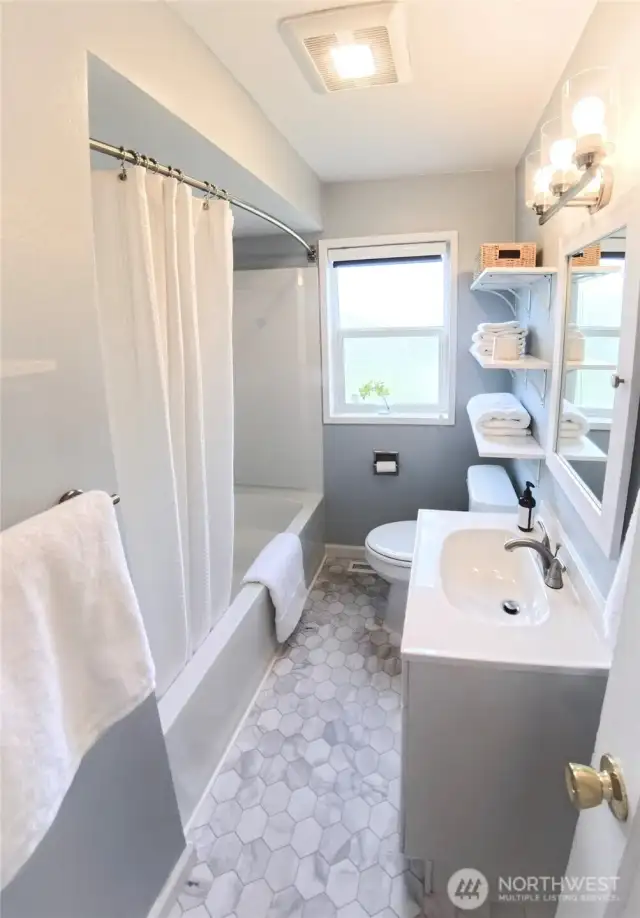 Beautifully remodeled bathroom conveniently located between both bedrooms at the center of the hallway.