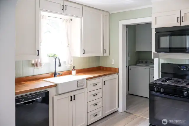 Kitchen flows into laundry room with convenient outdoor access.