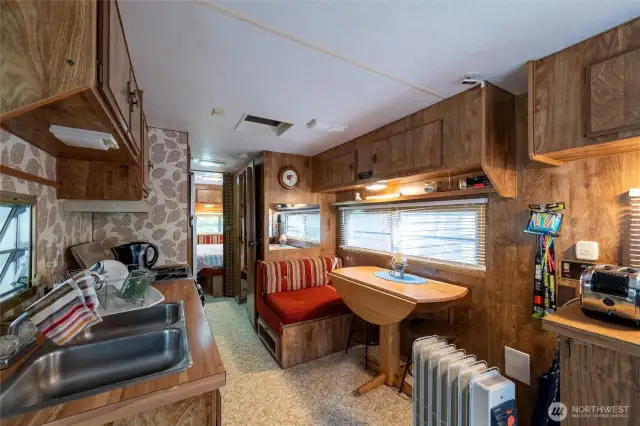 Kitchen also has dining table.
