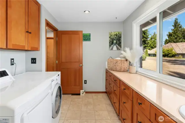Large laundry/mudroom with a sink and ample storage