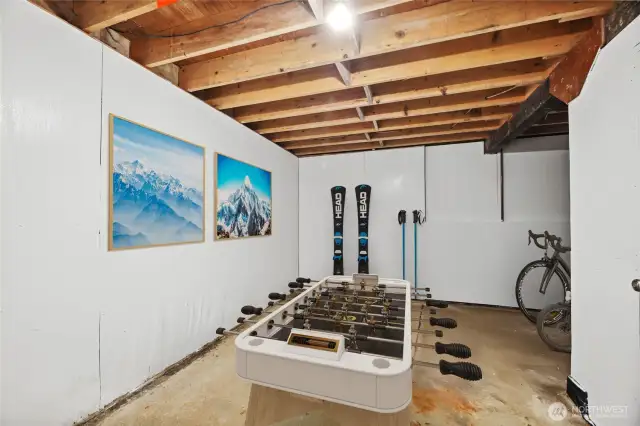 Bike/gear storage, shop, convert to garage and shop or additional living space. Virtually staged photo.