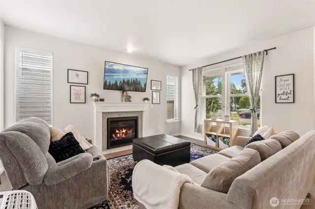 As you enter, to your right you will find the family room, beautiful gas fireplace with mantel, large windows and gorgeous flooring.