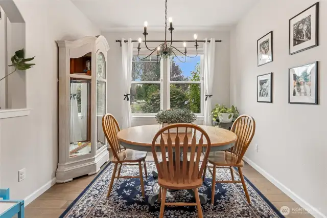 View of the formal dining room from the kitchen, the cutout to your left to the entry really opens up the space, large windows, just a lovely place for family meals.