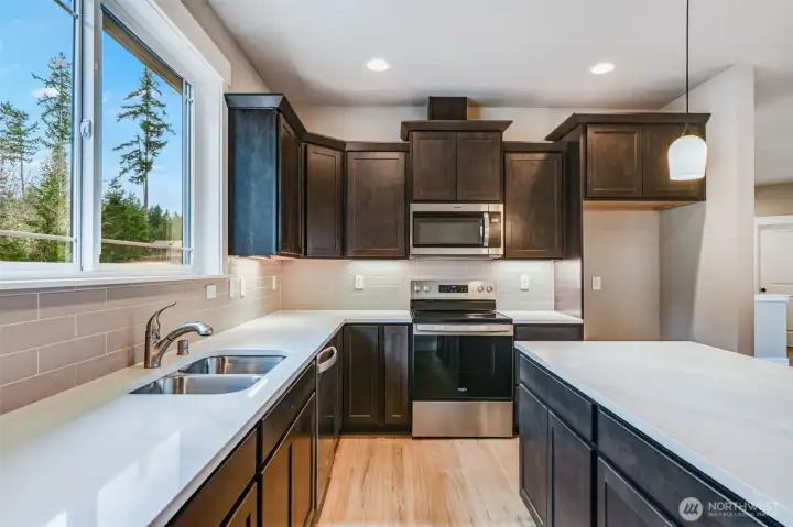 Kitchen features full slab quartz counters