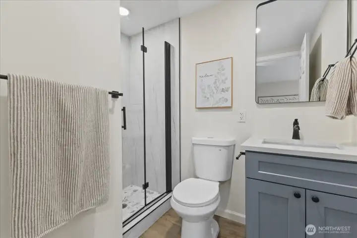 Stunning surround and granite counters in this primary bath.