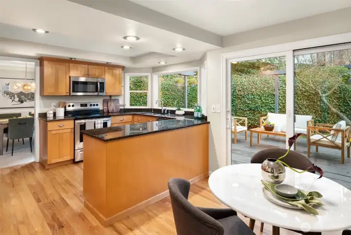 A breakfast nook overlooks the lower level family room & has a slider leading out to the freshly painted back deck, perfect for summer BBQs & dining al fresco!