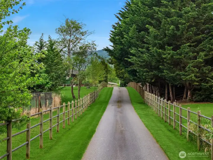 Gated entry with long paved driveway.