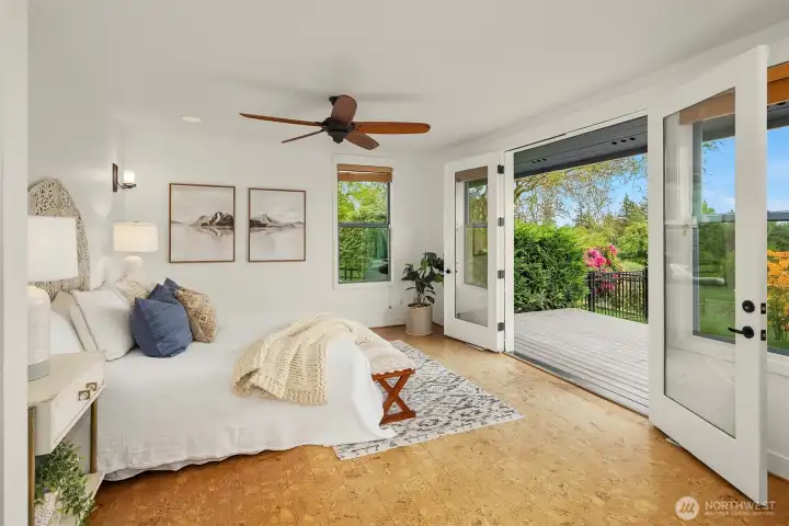 primary bedroom with pastoral and valley views, French doors to deck