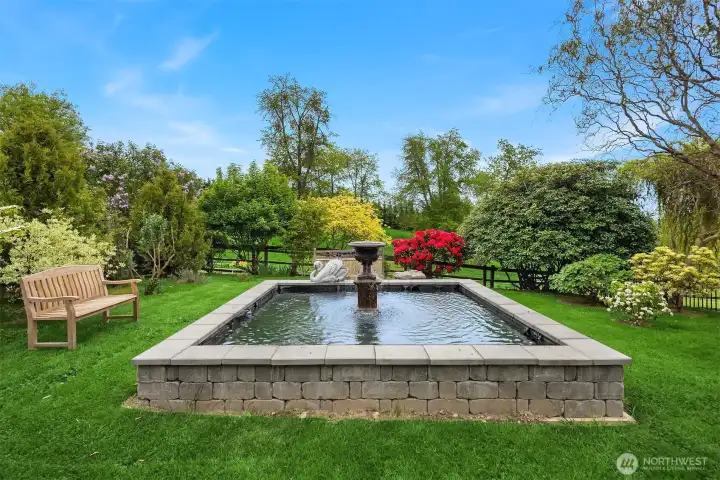 Gorgeous side yard off primary suite with water feature