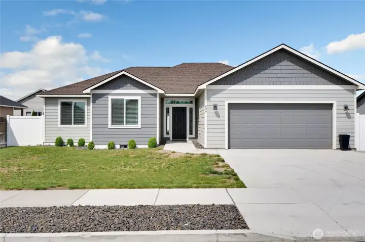 Front exterior angle highlighting driveway, garage, and covered entry