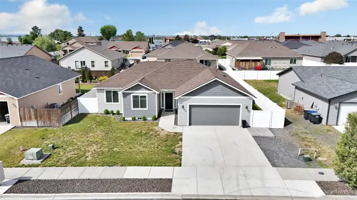 Front exterior view of home with driveway, landscaping, and entry access