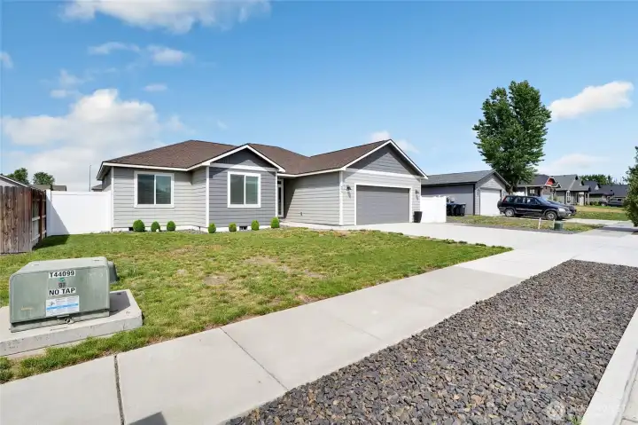 Corner exterior perspective showing yard space and neighborhood setting
