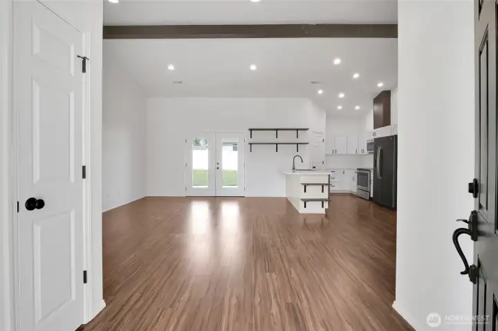 Open-concept living area with wood flooring and recessed lighting