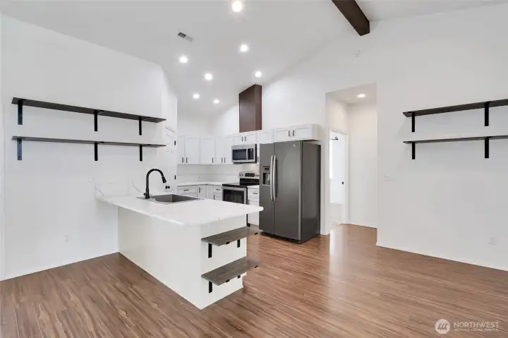 Kitchen and dining area with open-concept design and floating shelves