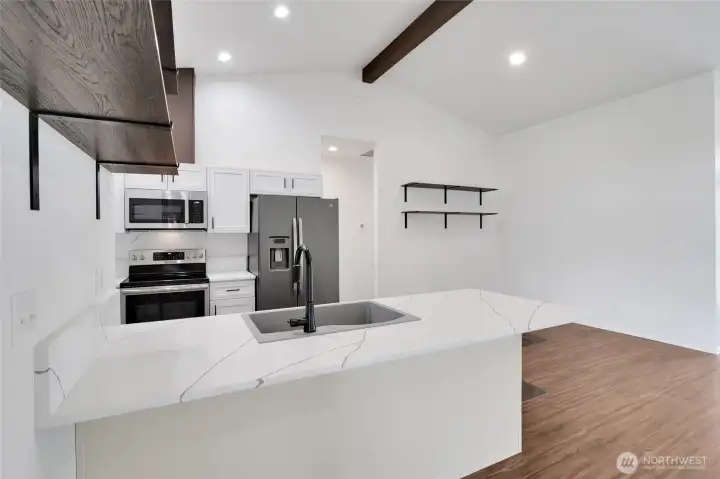 Kitchen with center island, stainless appliances, and cabinetry storage