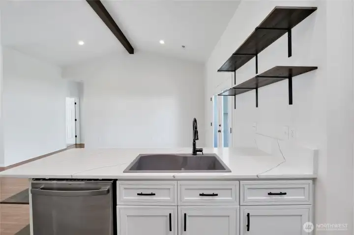 Kitchen workspace with quartz-style counters, cabinetry, and recessed lighting