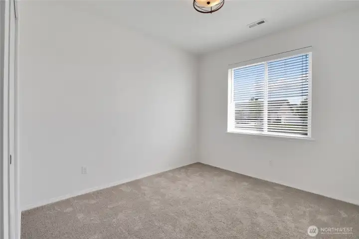 Additional bedroom with window, closet, and natural light