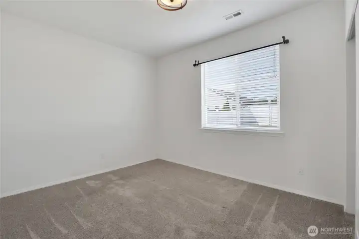 Additional bedroom or office space with window and closet