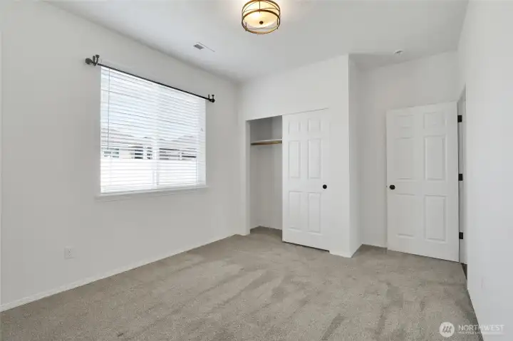 Bedroom with natural light and closet access
