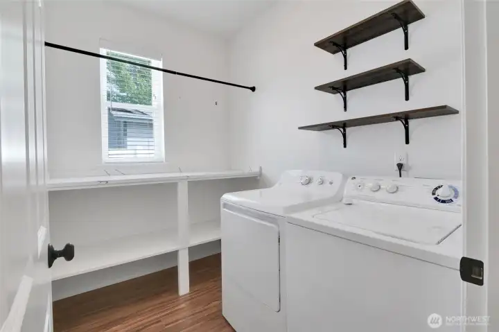 Laundry room with washer/dryer hookups and shelving storage