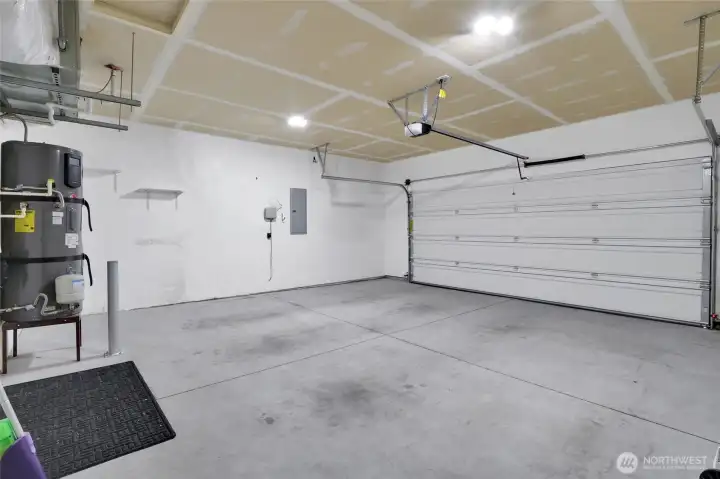 Attached garage interior with overhead lighting and storage space