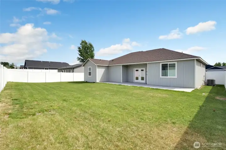 Fully fenced backyard with lawn space and rear exterior view