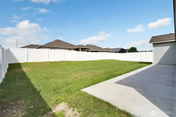 Backyard and patio connection with fenced lawn area and exterior access