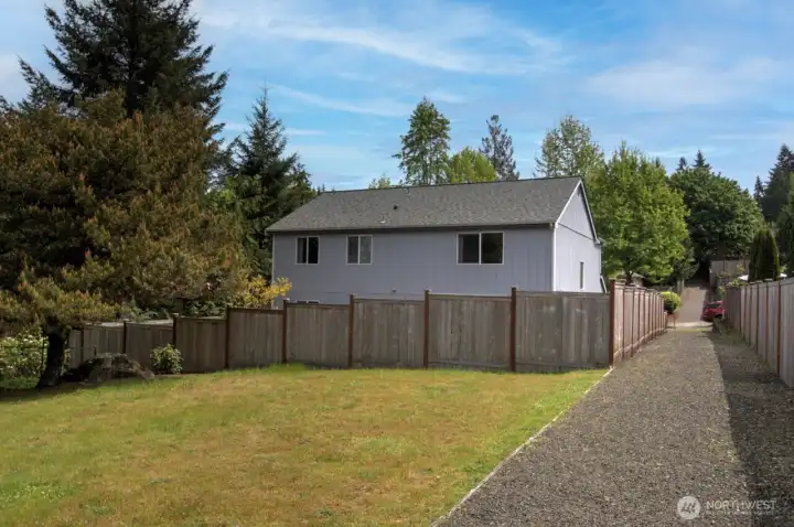 Looking from the neighborhood resource parcel, with open space and a walking path. The 50 year roof on the home is approximately 10 years old.